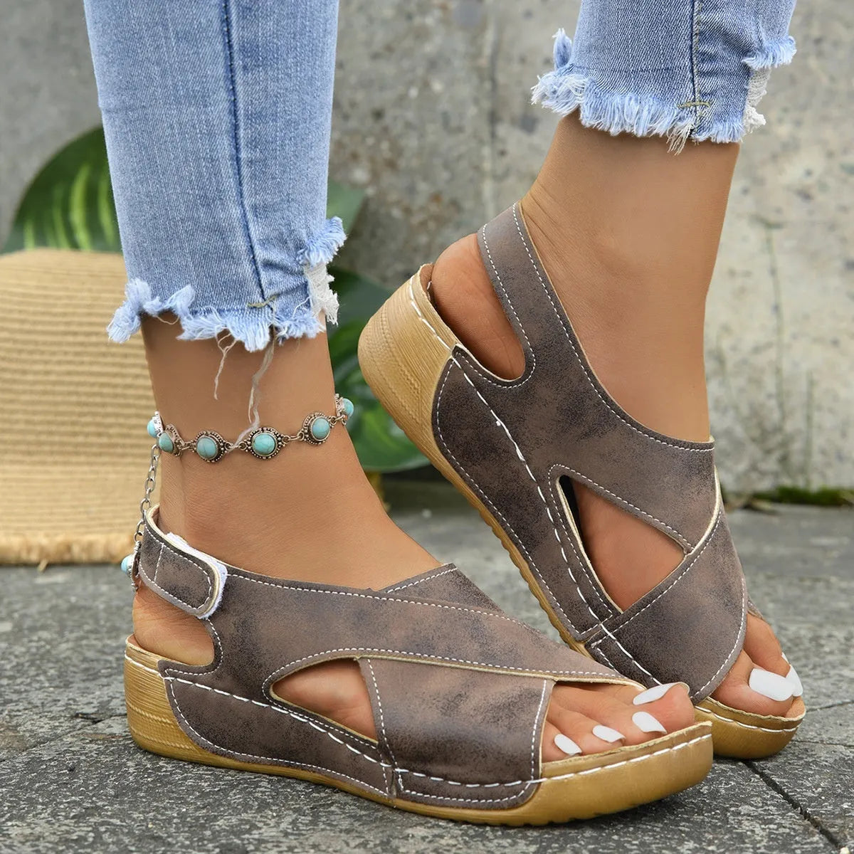 Brown Roman platform sandals with open toe and Velcro strap on a white background.