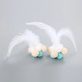Colourful cat toy feather bouncy ball with pink feathers on a white background