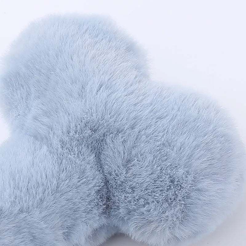 Vocal bone plush dog toy for aggressive chewers in blue, pink and yellow colours with internal squeaker
