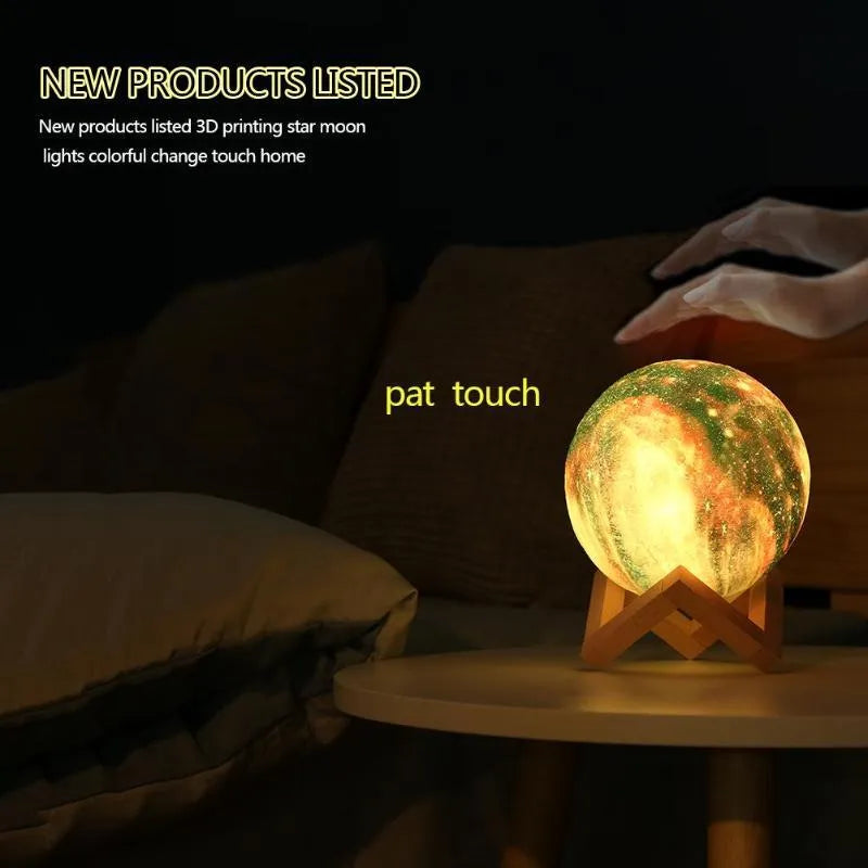 3D printed spherical lunar night light on a table showing colour-changing LED illumination.