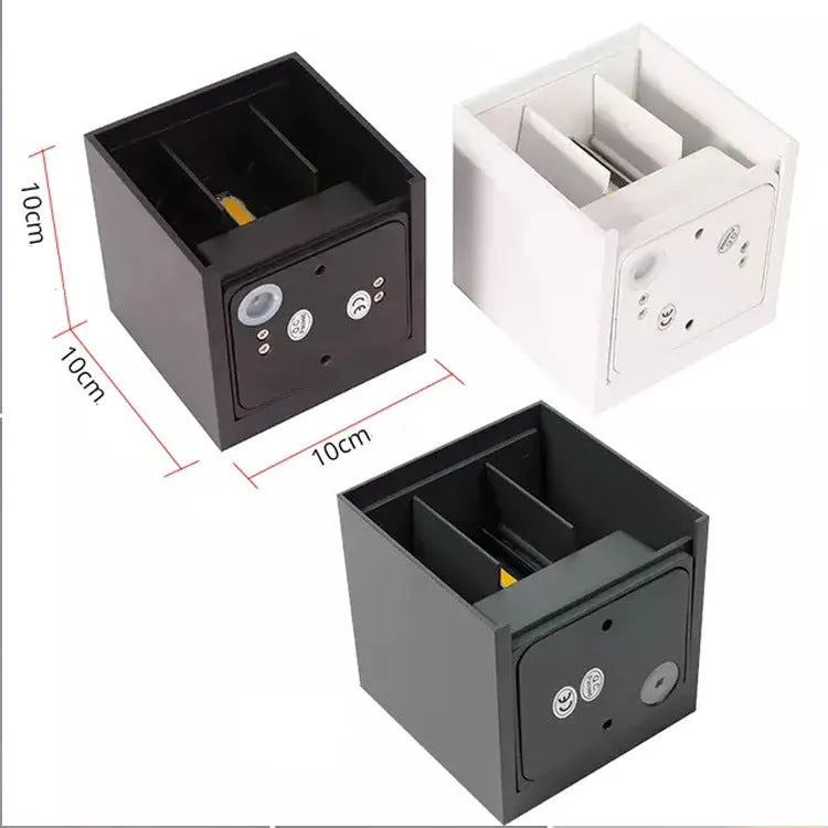 Square black aluminium alloy LED wall lamp mounted on a brick wall, showing 360-degree light emission.