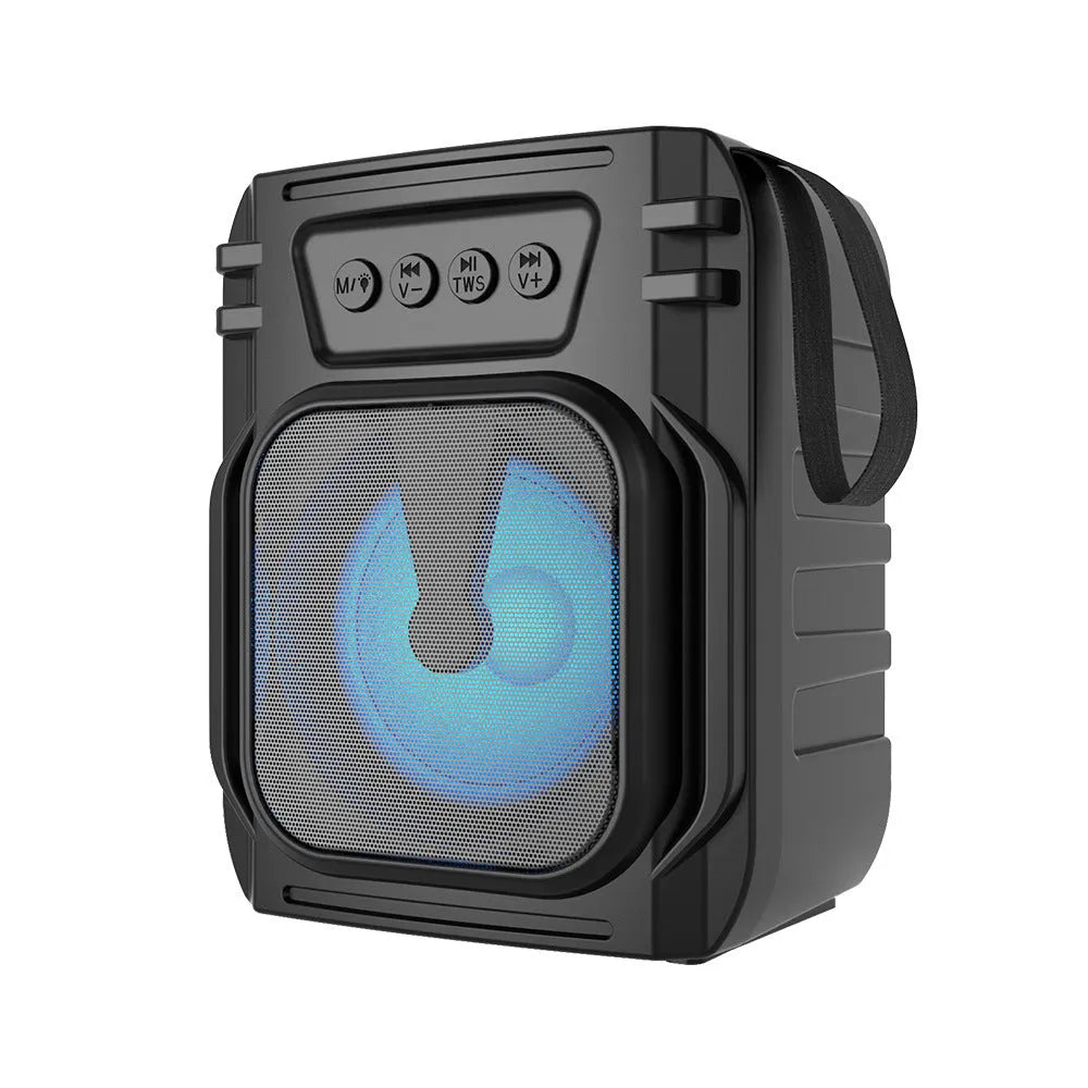 Compact portable Bluetooth speaker with USB charging cable on desktop