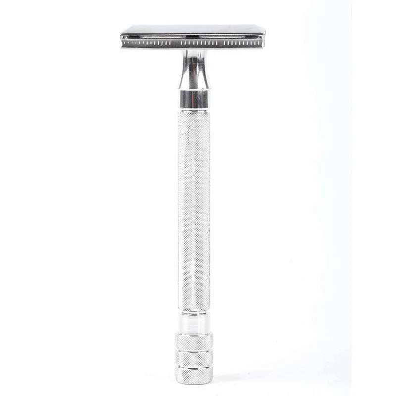 Traditional manual shaving razor and brush set in silver and black finish on a wooden surface.