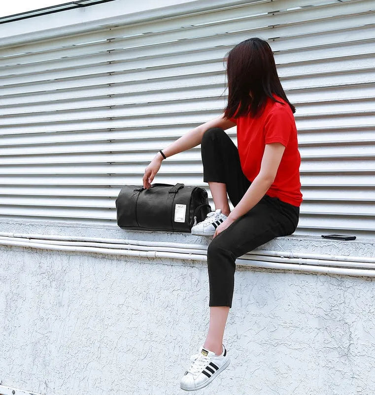 Black waterproof sports bag with separate side shoe compartments and a diagonal shoulder strap