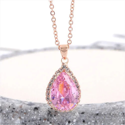 Rose gold electroplated necklace with water drop shaped geometric pendant and rhinestone detailing