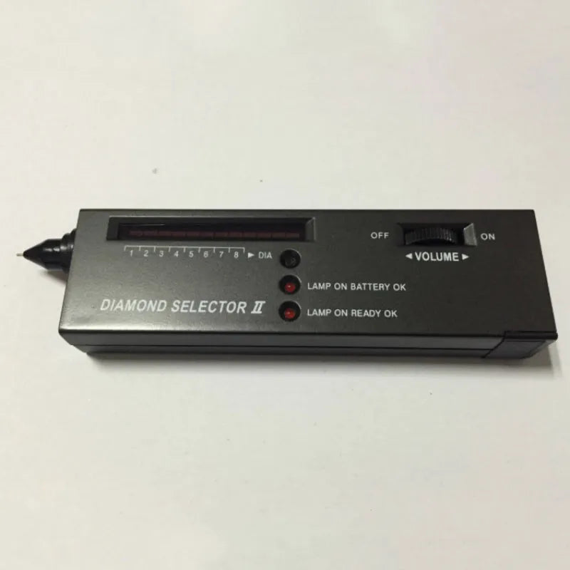 Black second generation diamond thermal conductivity tester with metal probe, shown with scale.