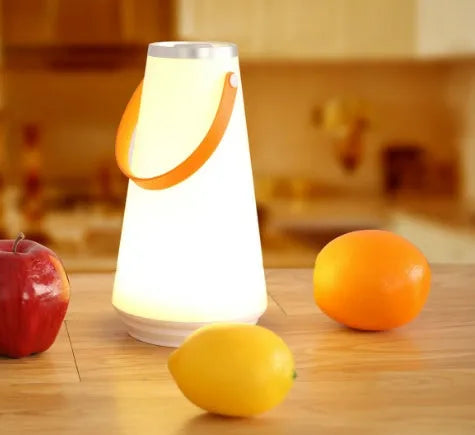White rechargeable LED bedside lamp with adjustable brightness on a table.