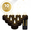 Set of four black S10 LED flameless tealight candles with flickering light, shown from the side.