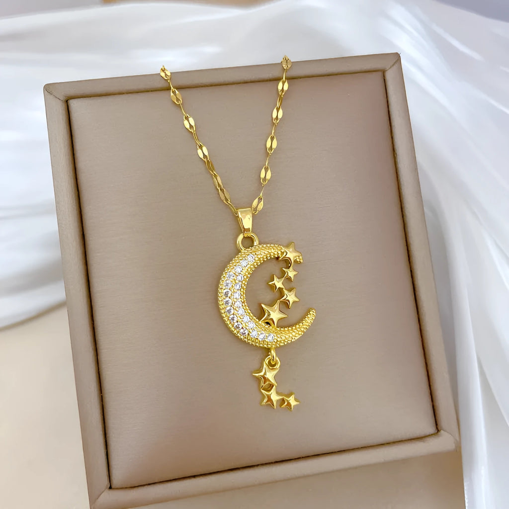 Moon pendant necklace with tassel design and diamond accents on stainless steel chain