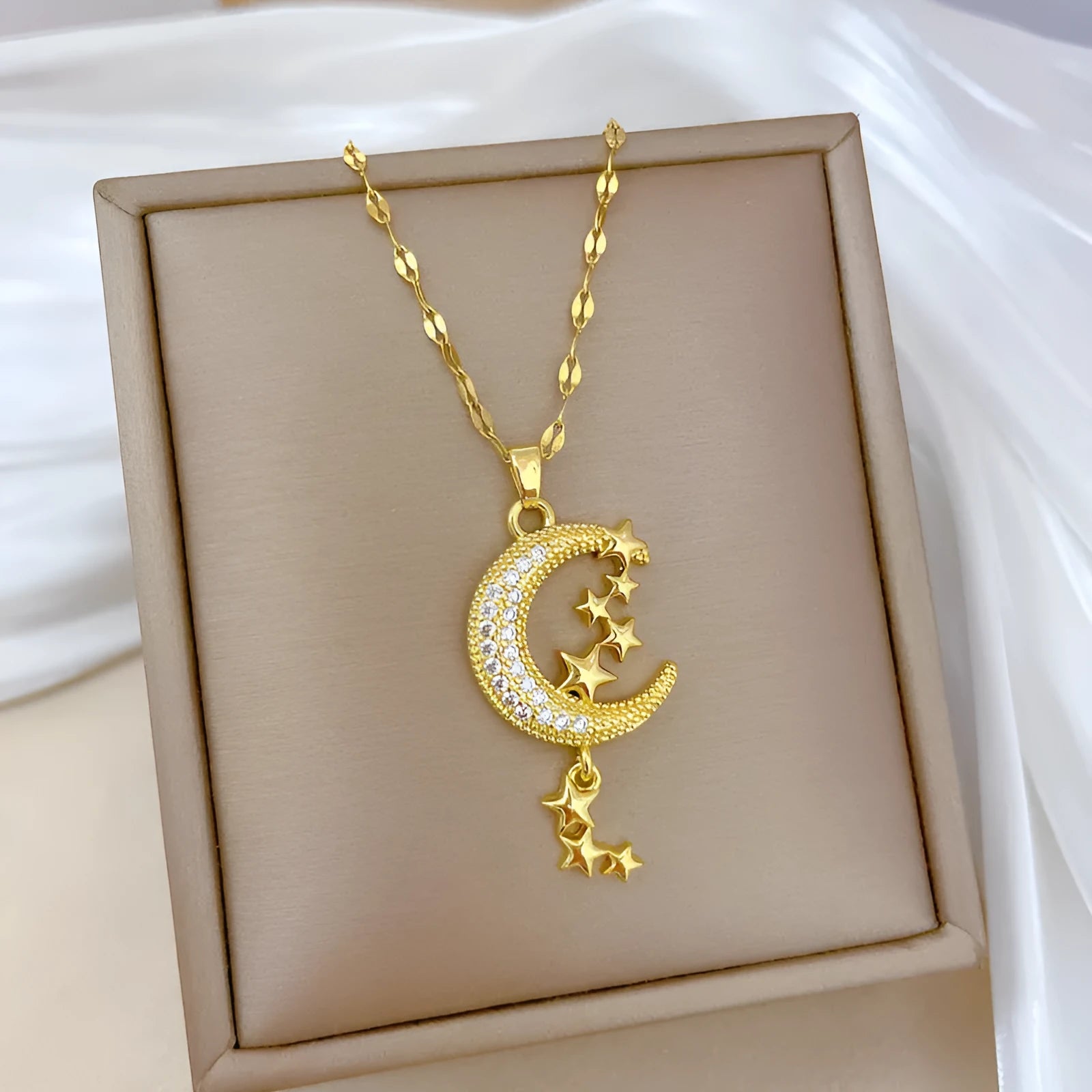 Moon pendant necklace with tassel design and diamond accents on stainless steel chain