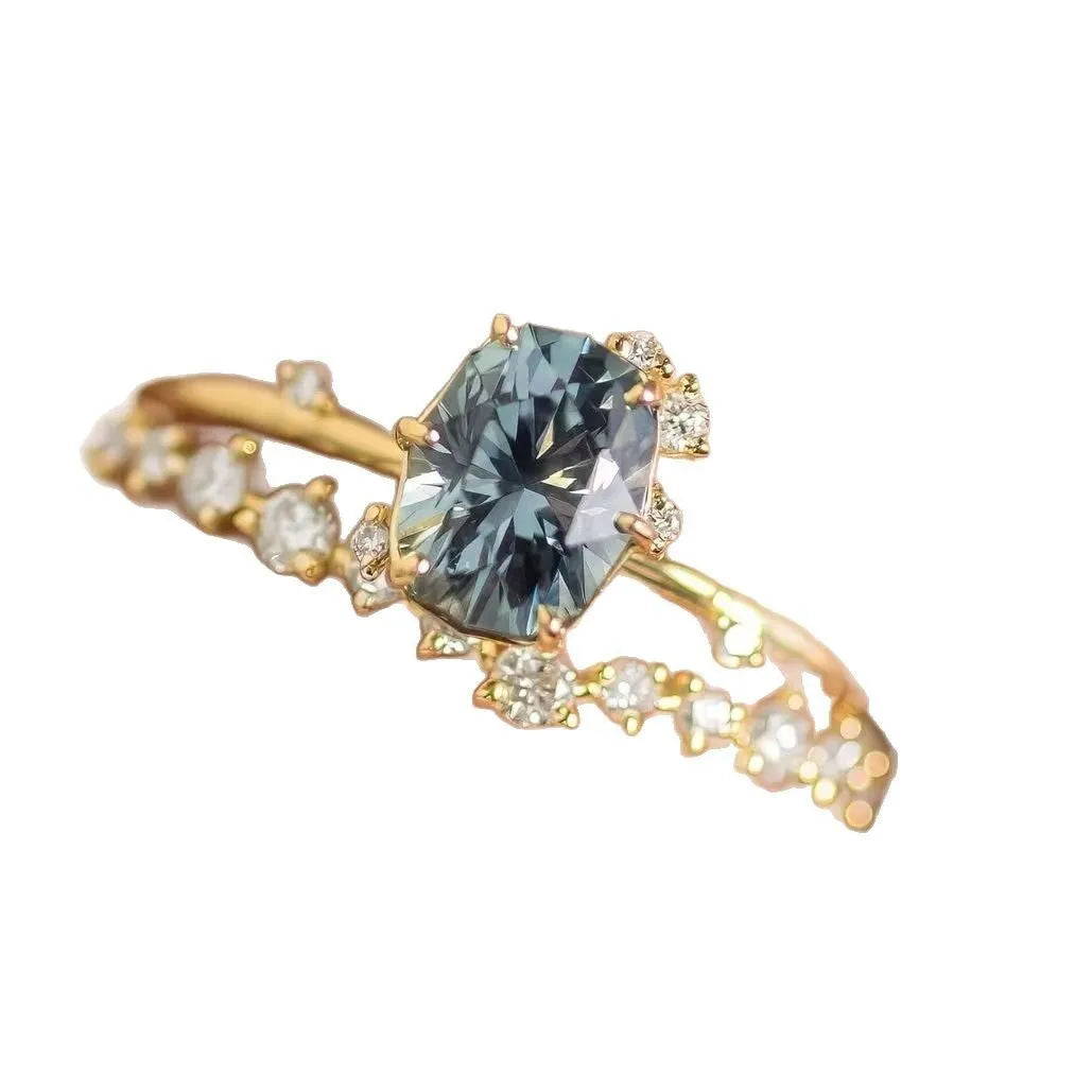 Gold-plated floral ring with green zircon stone, shown on female hand
