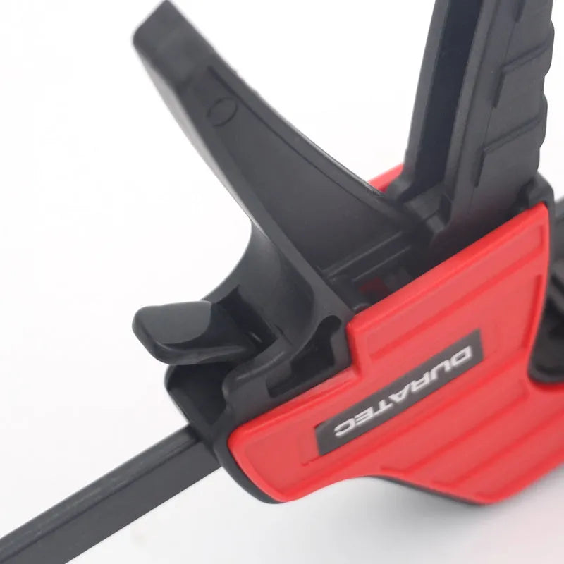 Black engineering plastic woodworking clamp with rubber grip and regression adjustment key