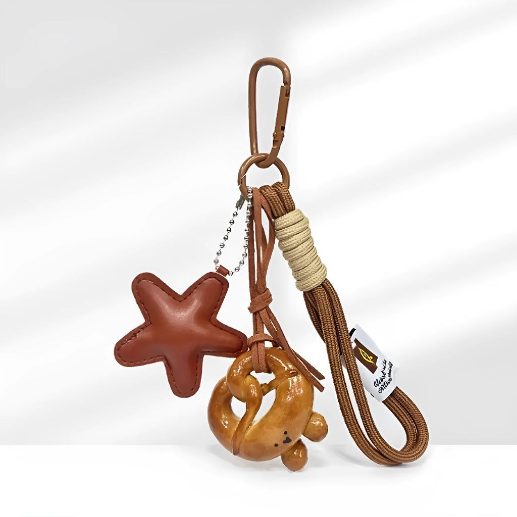 Handmade soda bread style handbag pendant with cartoon croissant design and brown star on brown strap