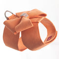 A pink microfiber dog chest strap with a large decorative bowknot, showing leash attachment ring.