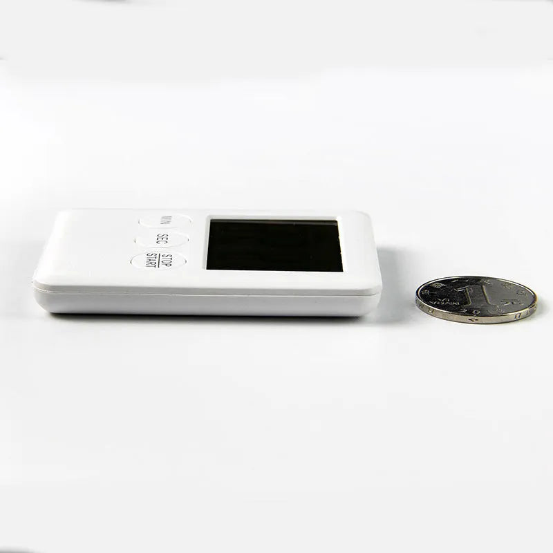 Digital kitchen timer with magnetic back and LCD display showing countdown time