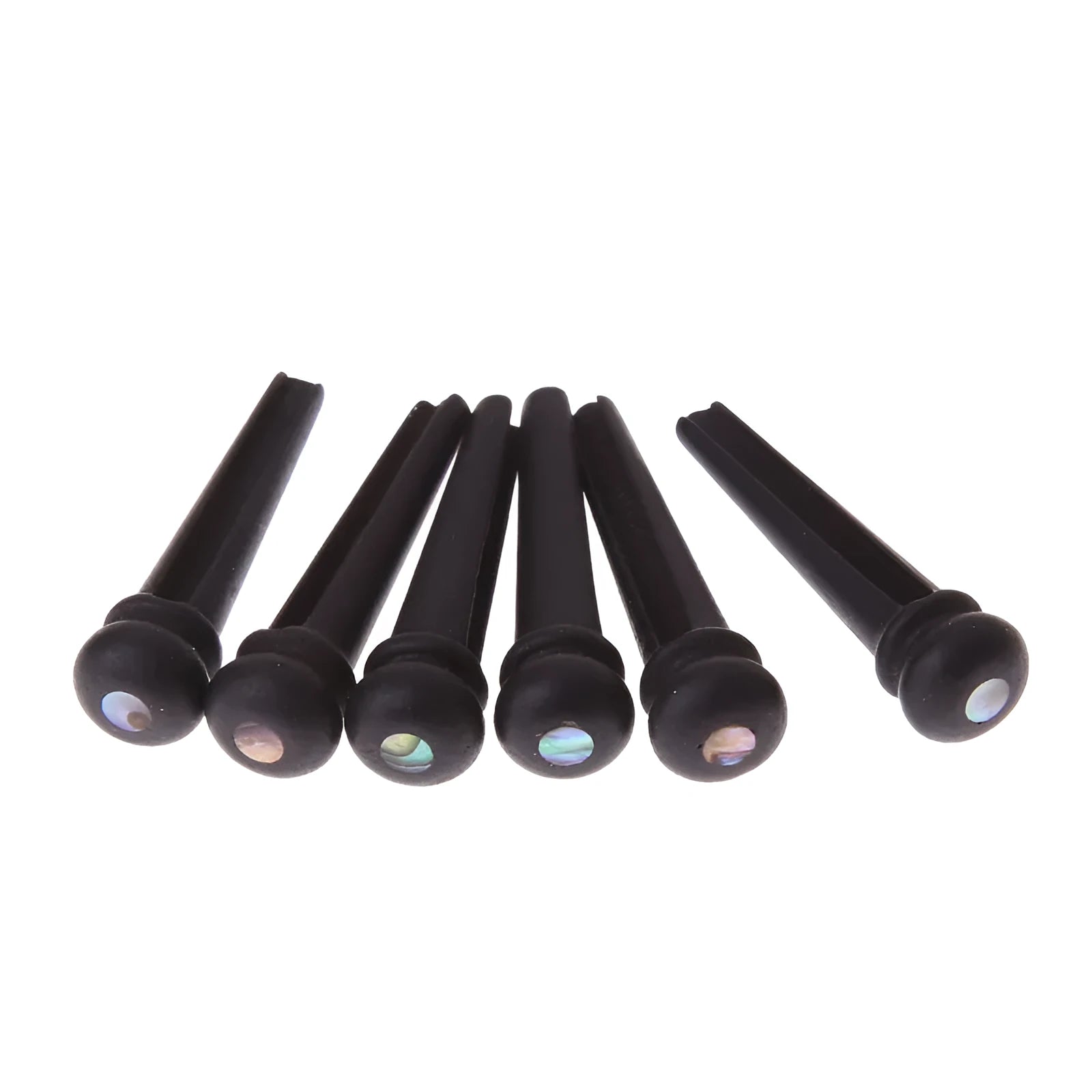 Six matt black ebony guitar string nails for folk acoustic guitars on a white background.