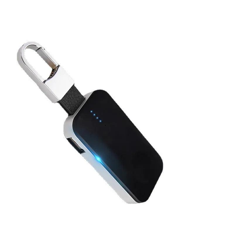 Black Apple Watch wireless charging power bank on a keyring, showing compact size.