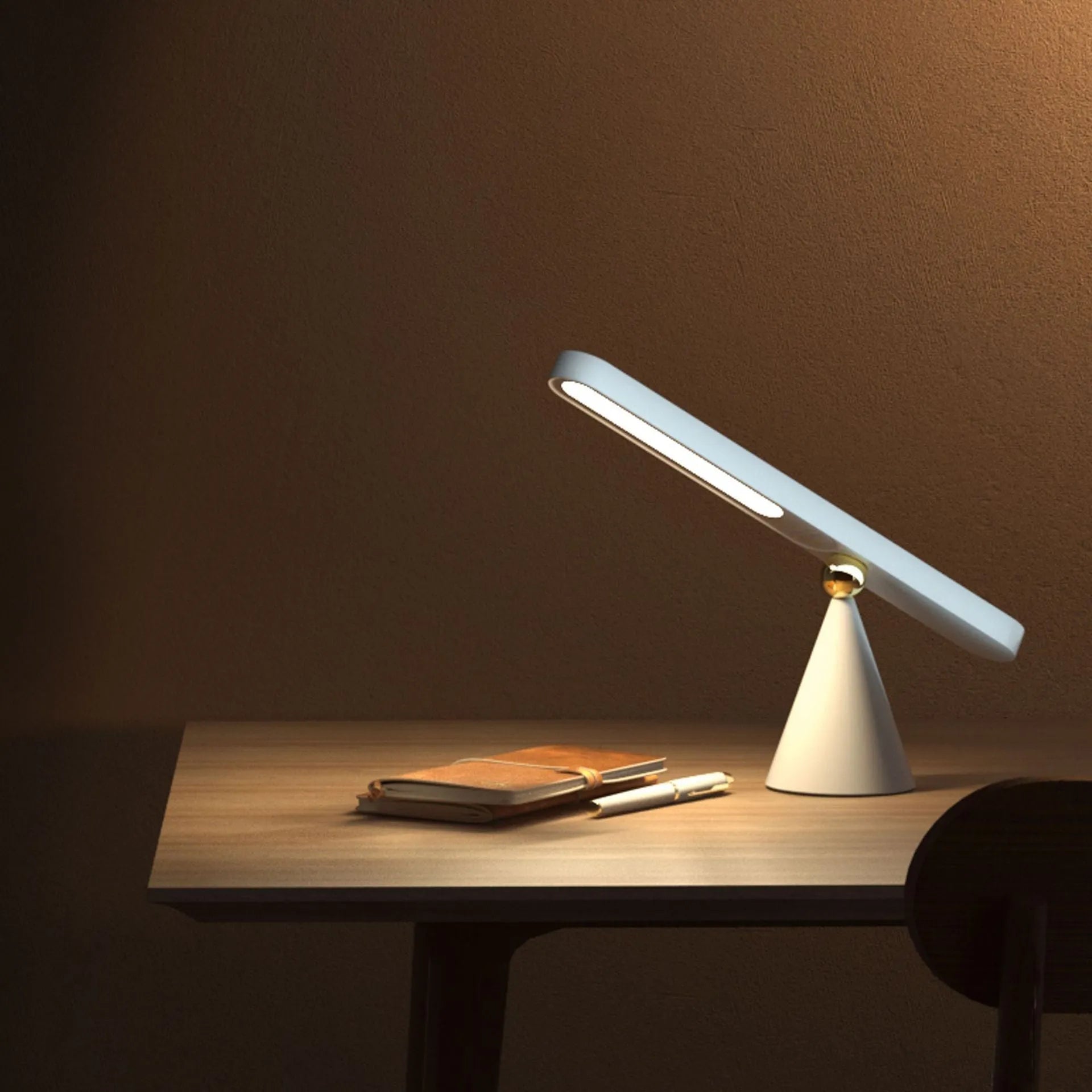 Geometric white desk lamp with magnetic base and USB cable on wooden table