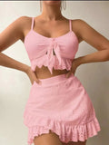 Women's solid colour three-piece bikini swimsuit with a split hip skirt.