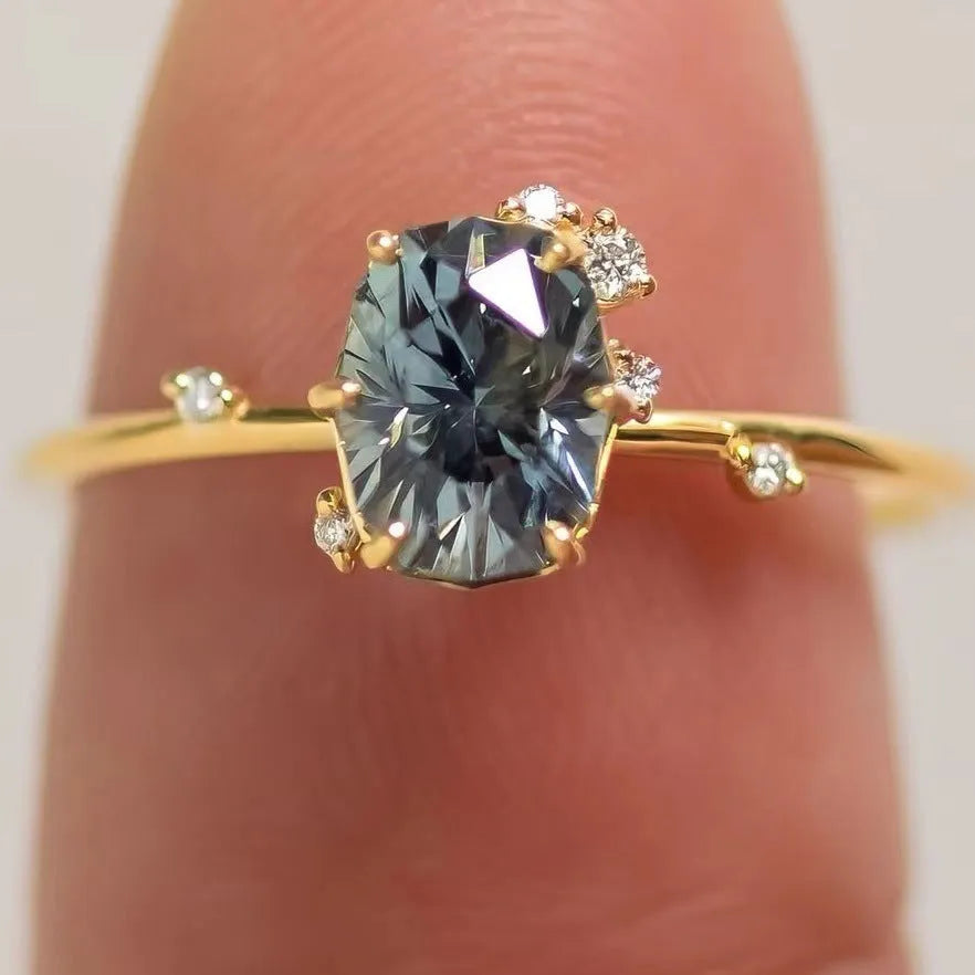 Gold-plated floral ring with green zircon stone, shown on female hand