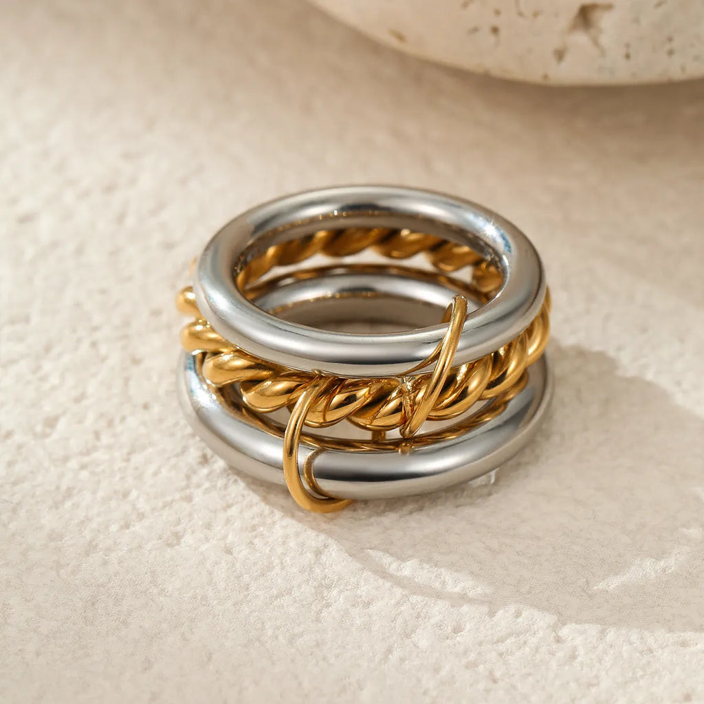Stackable stainless steel rings with 18K gold plating in colour matching bands, exaggerated modern design