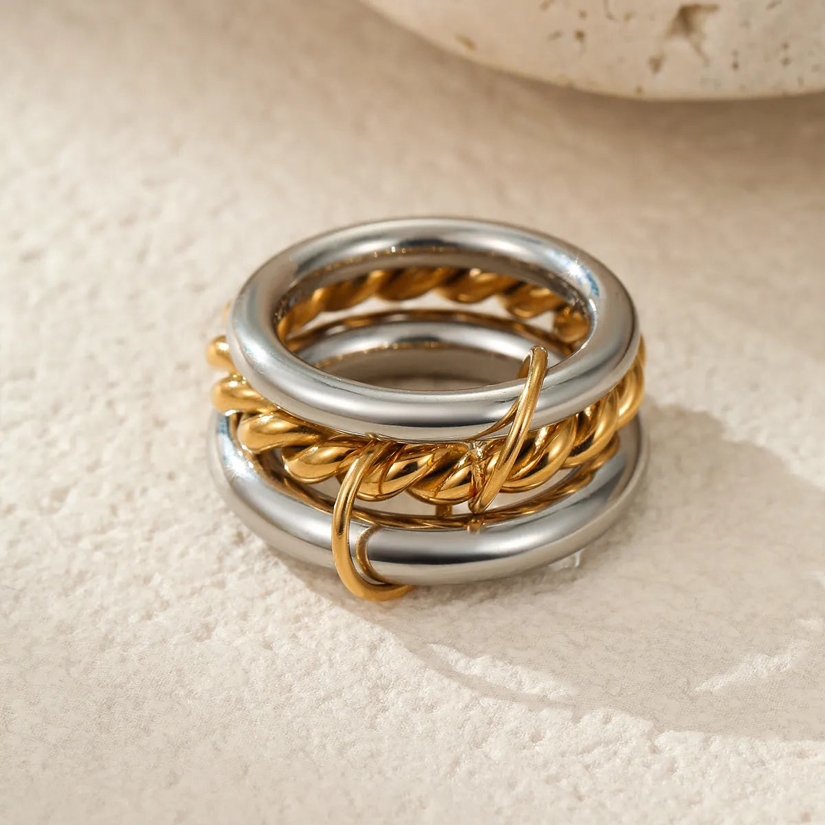 Stackable stainless steel rings with 18K gold plating in colour matching bands, exaggerated modern design