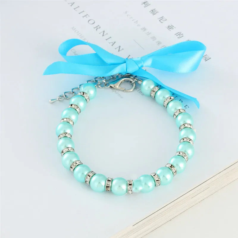 Adjustable dog necklace with imitation pearls, rhinestones, and ribbon bow for small pets