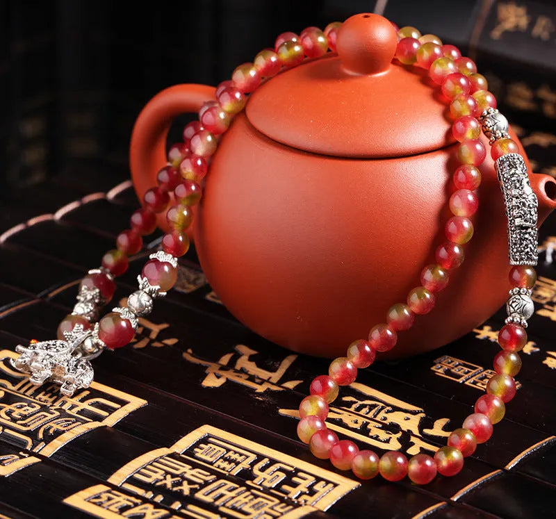 Handcrafted watermelon crystal bracelet with Chinese knot design in geometric shapes