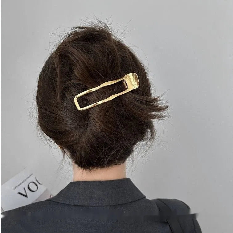 Gold and silver zinc alloy women's hair barrettes in arc, square, and triangle shapes.