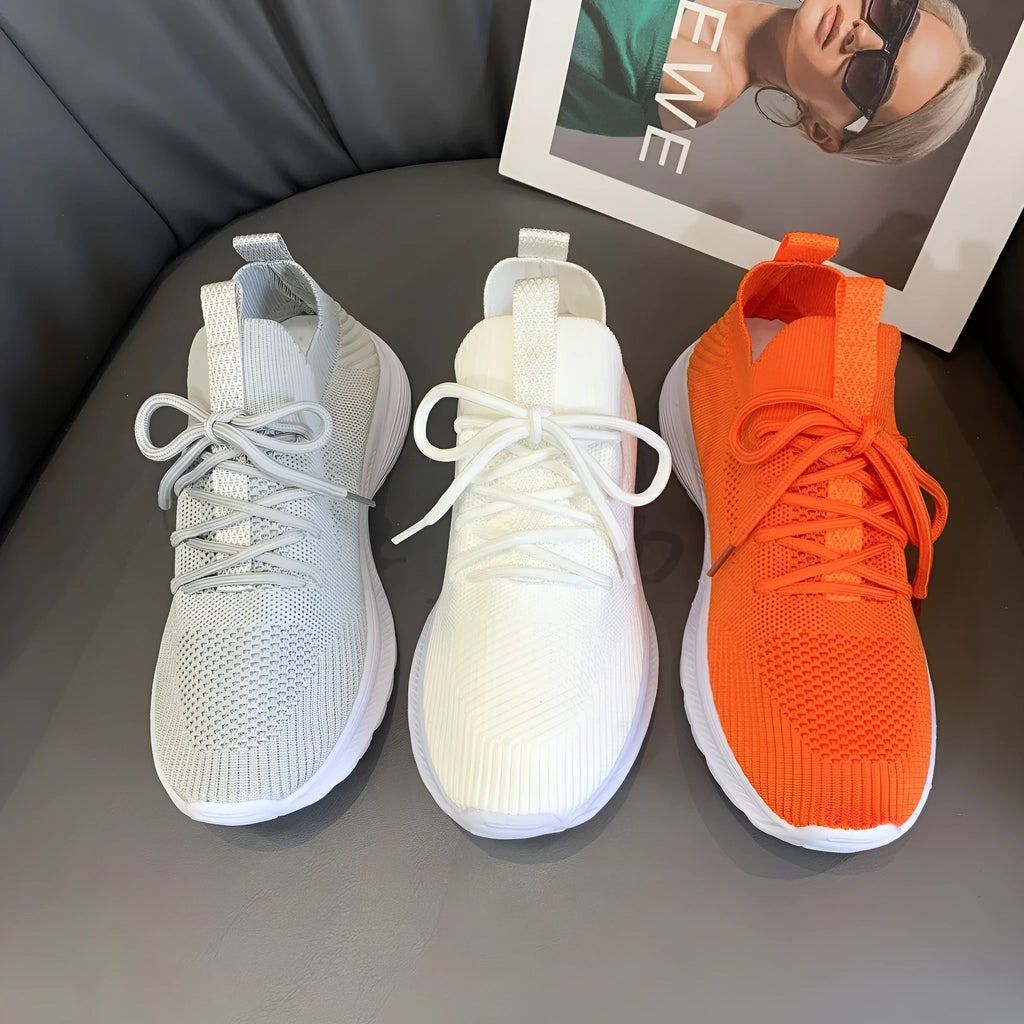 Women's mesh running shoes in creamy white with flat rubber sole and low-top design