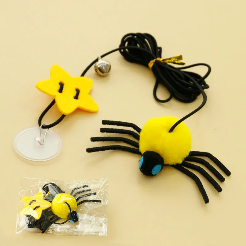 Red and yellow hanging door cat toy with elastic rope, feather, bell, and spider attachments.