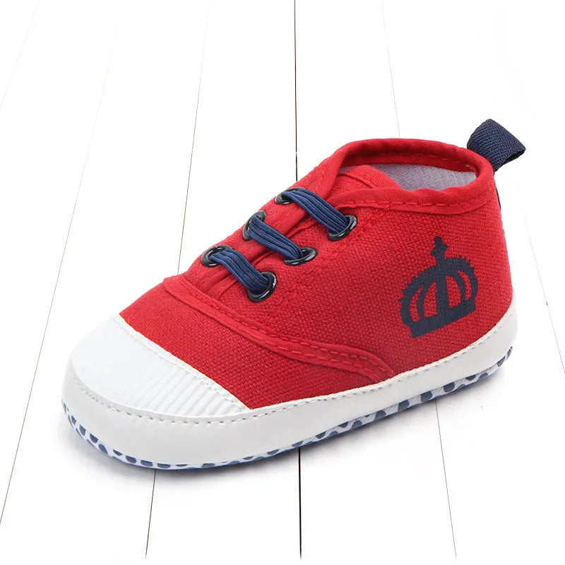 Canvas toddler shoes with elastic band in red and white on neutral background