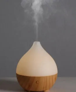 Asakusa wood grain finish vase-shaped USB aroma diffuser on a table.