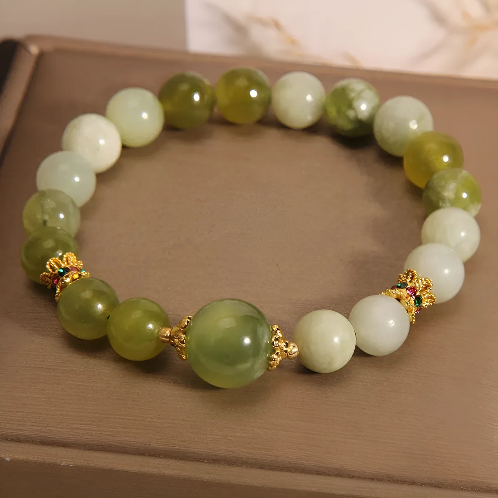 Women's bracelet made of green Xiuyan jade with an original sweet Mori style design.