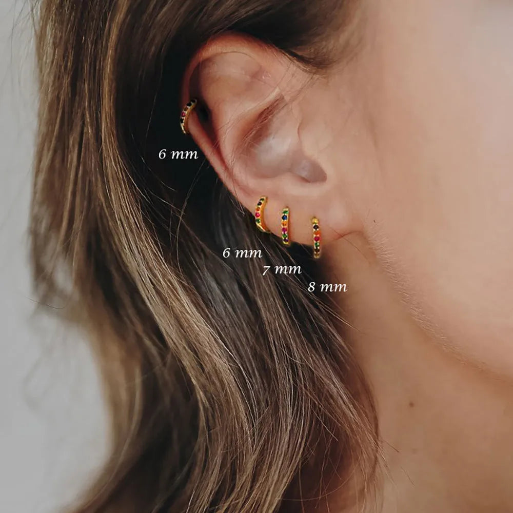 Round zircon geometric stud earrings in gold, rose gold, and silver colours on a white background.