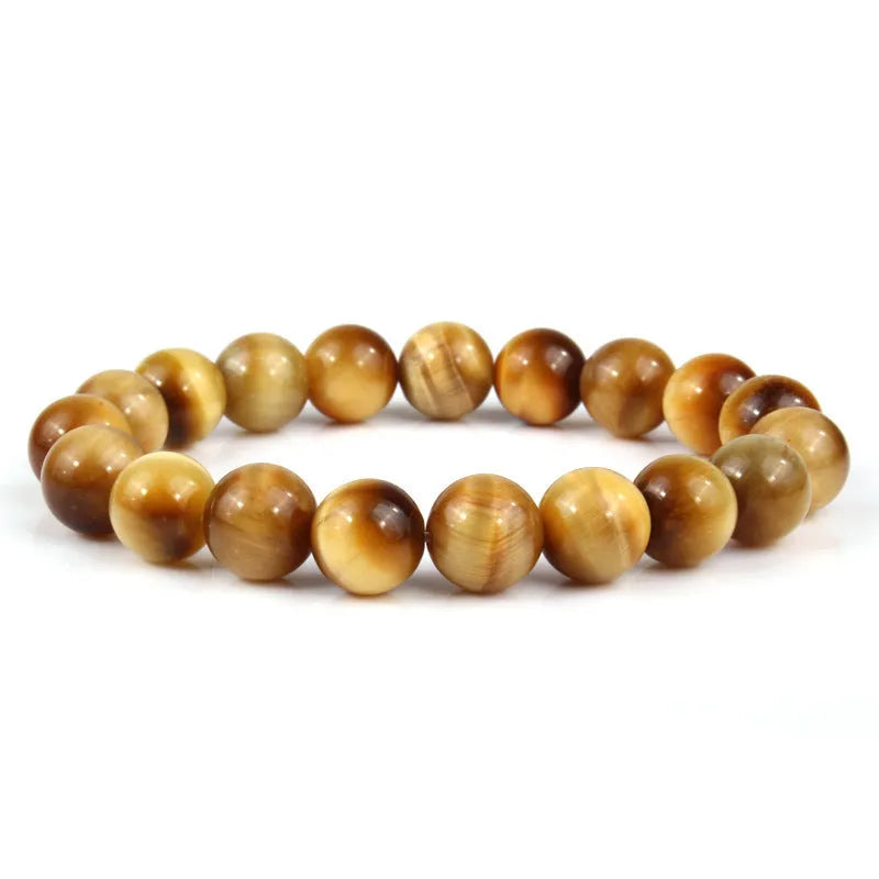 Natural tiger eye crystal bracelet with round beads in multiple colour options on a wrist.