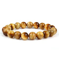 Natural tiger eye crystal bracelet with round beads in multiple colour options on a wrist.