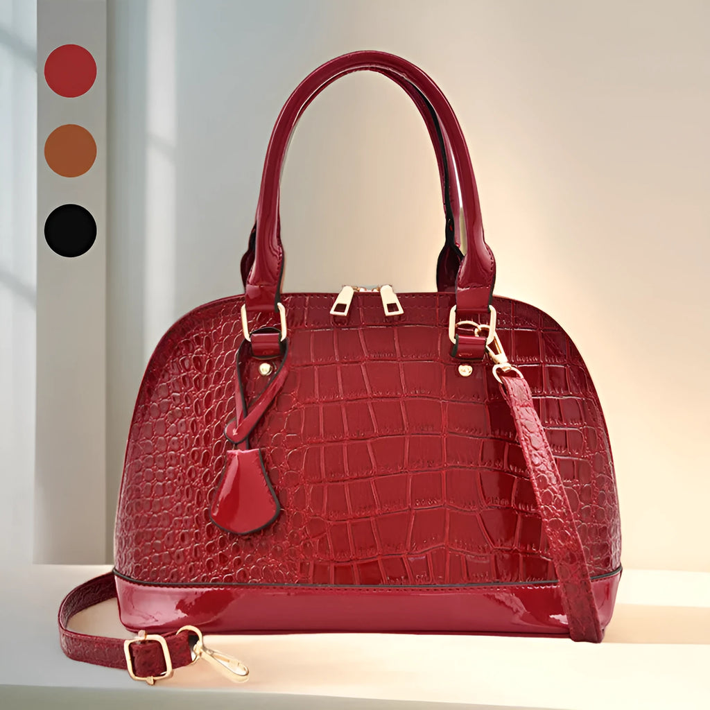 Large shiny black PU crossbody shoulder bag with shell shape design on a model.
