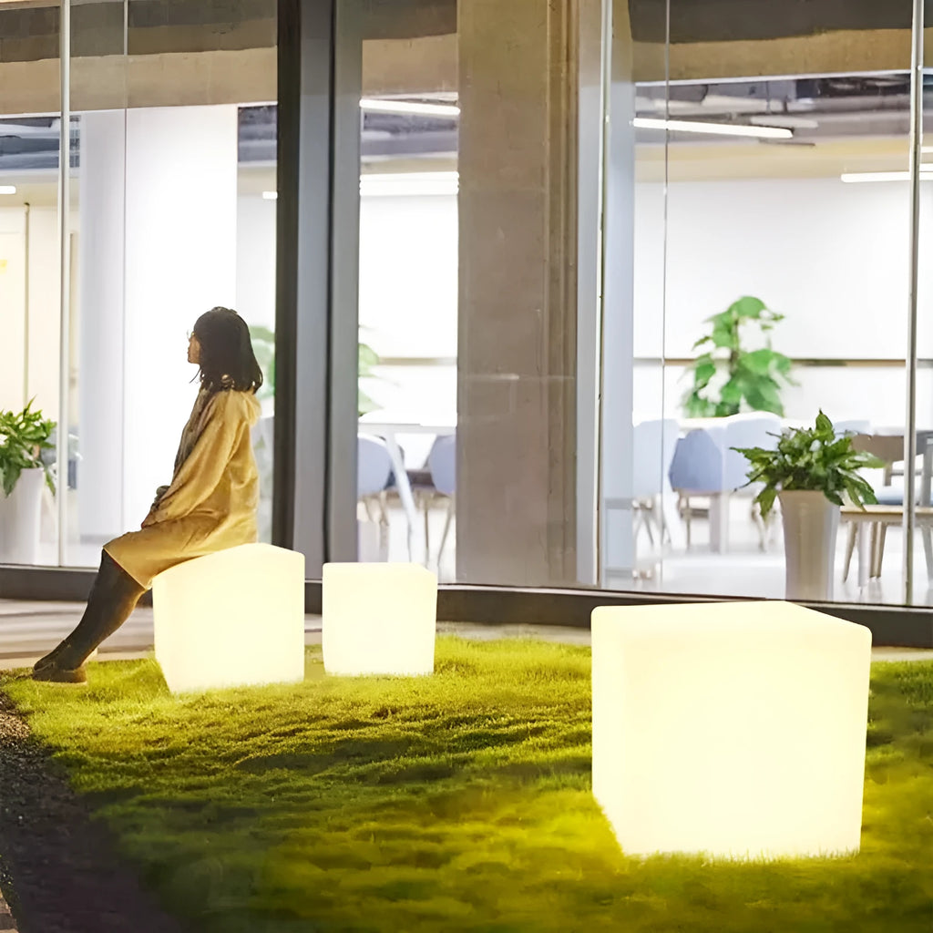 White square LED cube garden light stool with modern design, shown outdoors.
