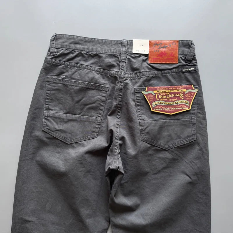 Men's grey cotton straight leg casual trousers laid flat showing mid waist and straight cut.