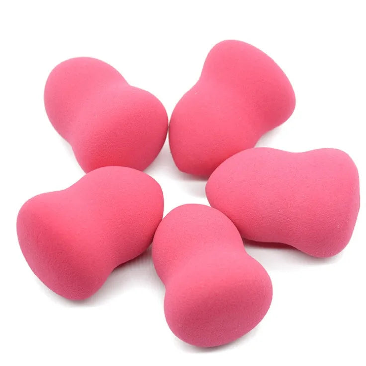 Pink teardrop-shaped makeup blending sponge on a flat surface