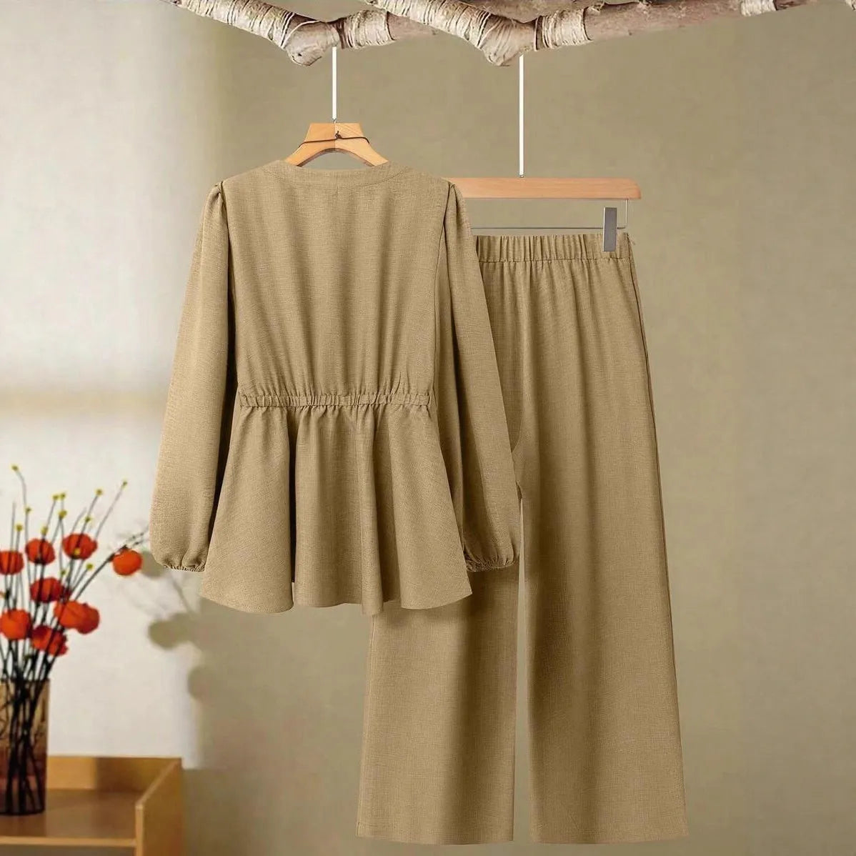 Women's long-sleeved two-piece polyester suit in khaki with button front top and matching trousers on model