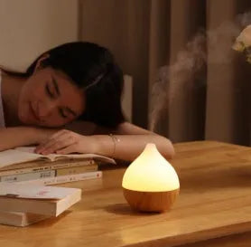 Asakusa wood grain finish vase-shaped USB aroma diffuser on a table.