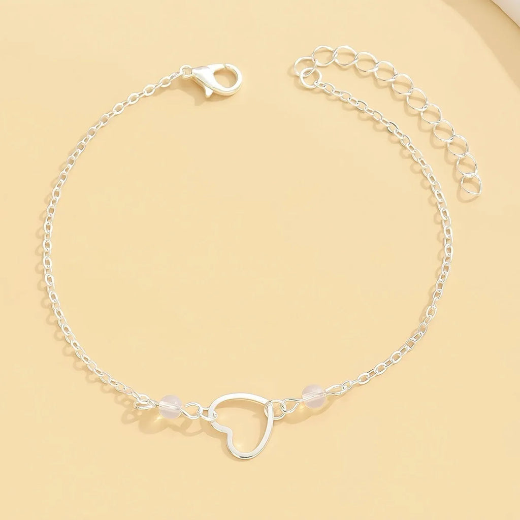 Adjustable women's anklet with heart-shaped pendant in gold and silver alloy metal