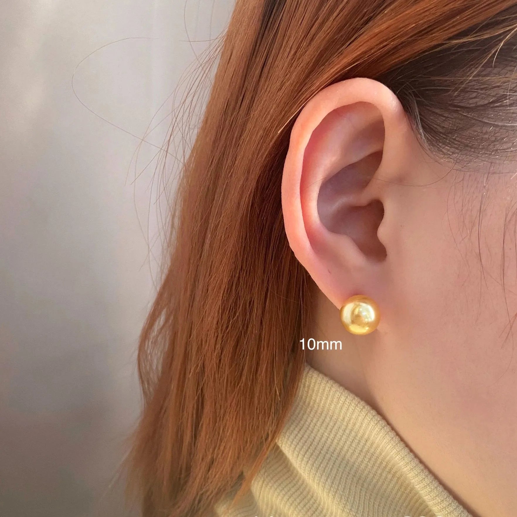 Large pearl stud earrings in geometric shape with eight awn star detail and pearl accents on silver background