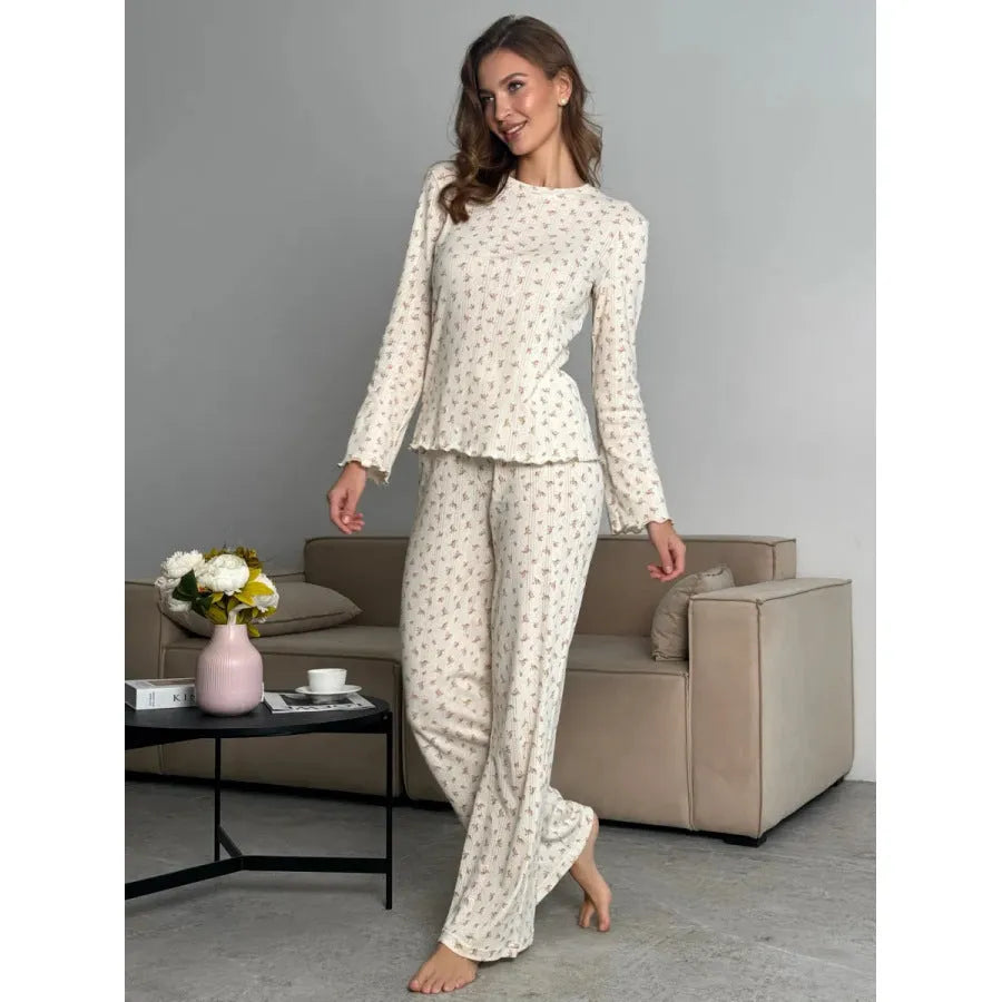 White floral print women's loungewear set with bell sleeve top and wide leg trousers.