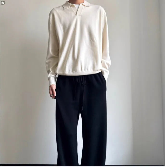 Pure wool lapel-collar polo sweater in a loose fit, shown in milky white.