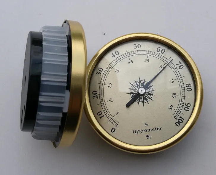 Analogue thermometer and hygrometer with silver aluminium outer ring and dial showing temperature and humidity scales.