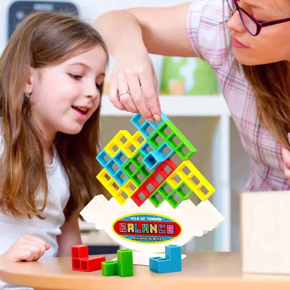 Plastic balance stacking game with coloured blocks on chassis for family play
