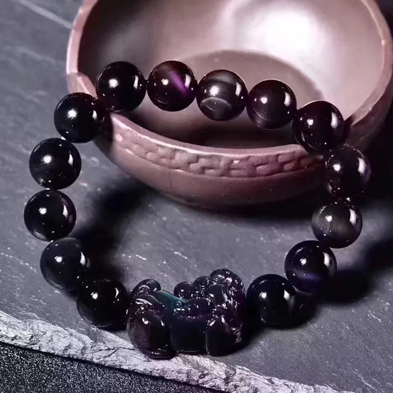 Natural ice colour eye obsidian crystal bracelet on a wrist, showing bead size options.